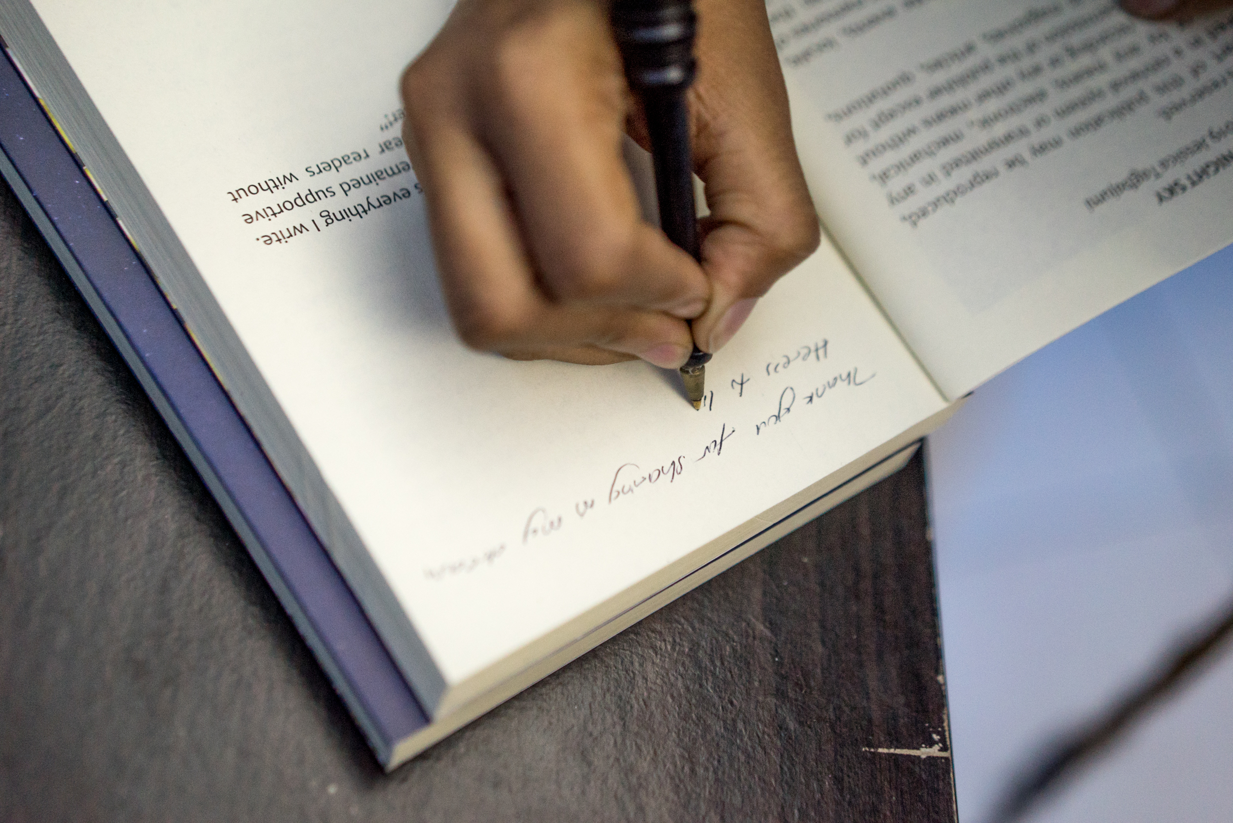 Jessica signing a booki for Wings of the night sky